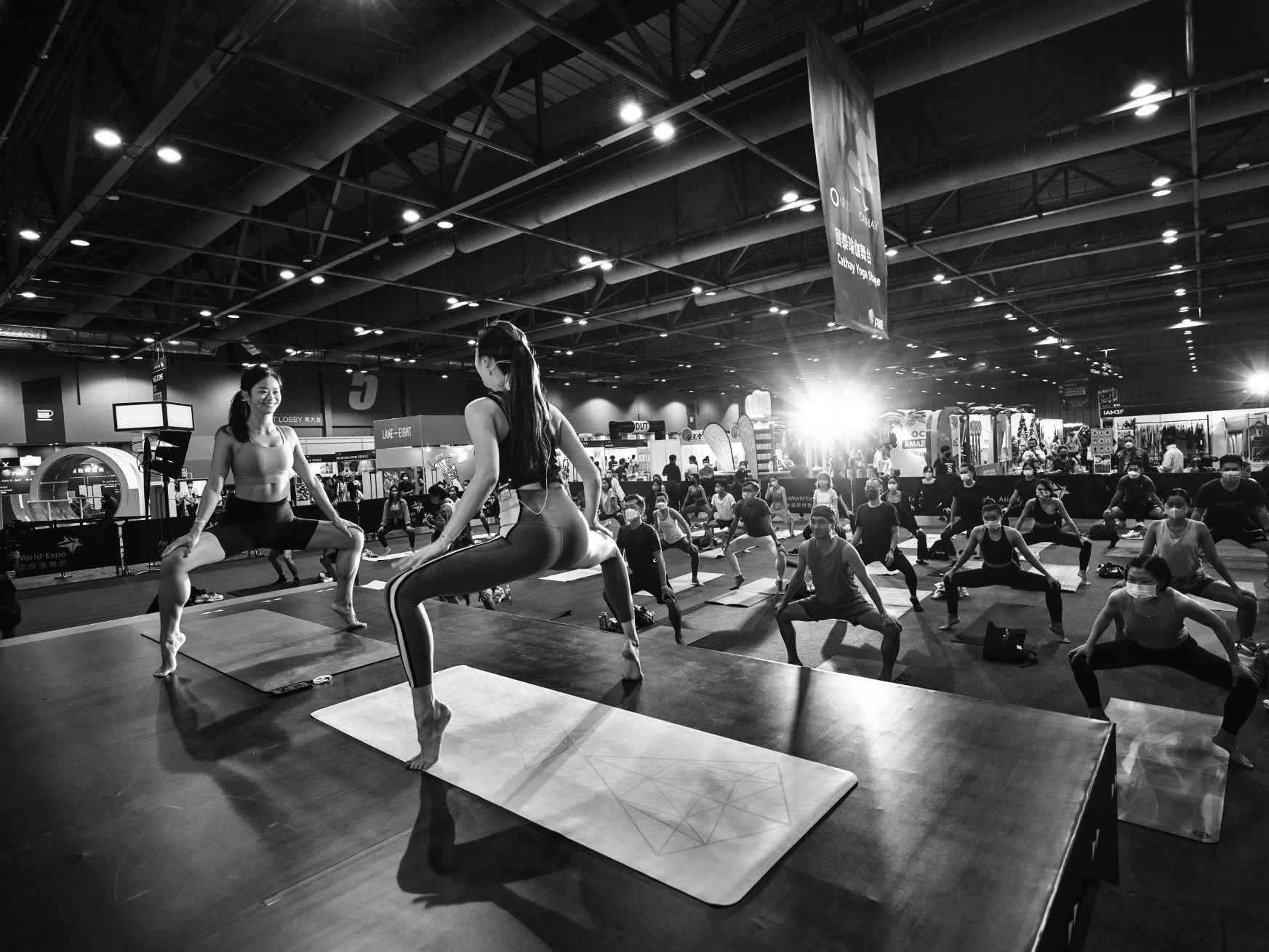 A large yoga class at an industry expo